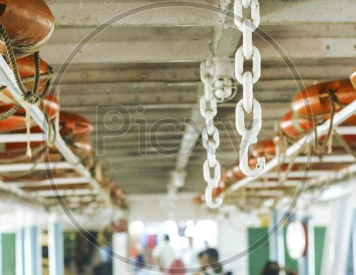 Double Line Of Lifebuoy Ring Floatation Inside A Traveler Ship . Vertical View Blurry Background.
