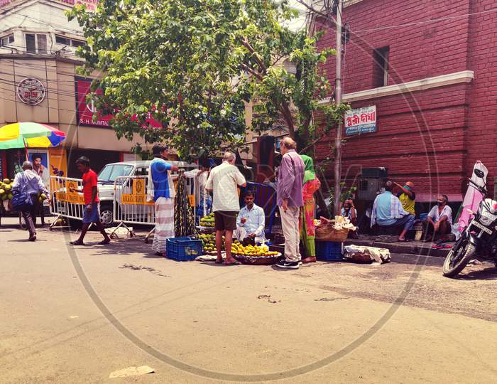 Masked Crowd buying fruits on street during unlock 2.0 at Kolkata, West Bengal, India on 1.7.2020