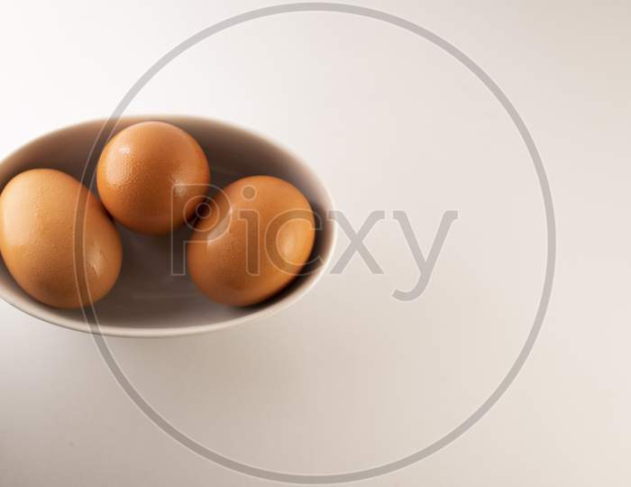 eggs in a bowl on a white background.