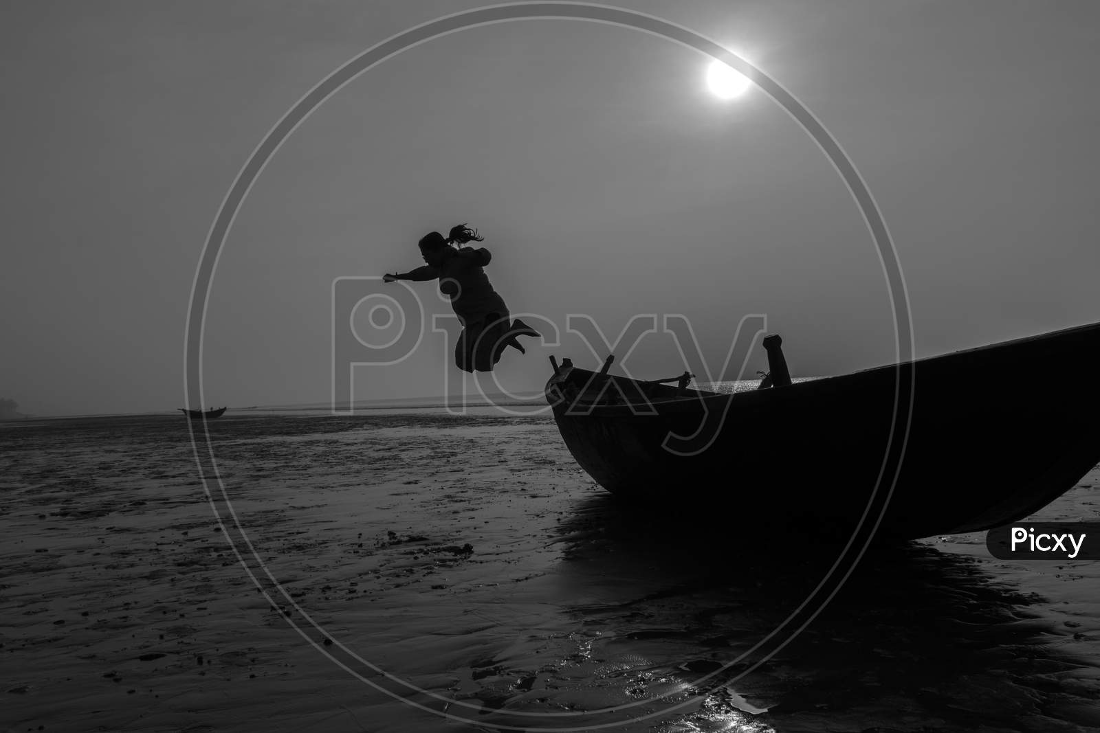 An Woman Jumping From A Boat On A Sea Beach