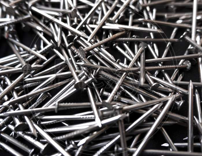 Closeup Shot Of A Pile Of Steel Nails On A Black Background