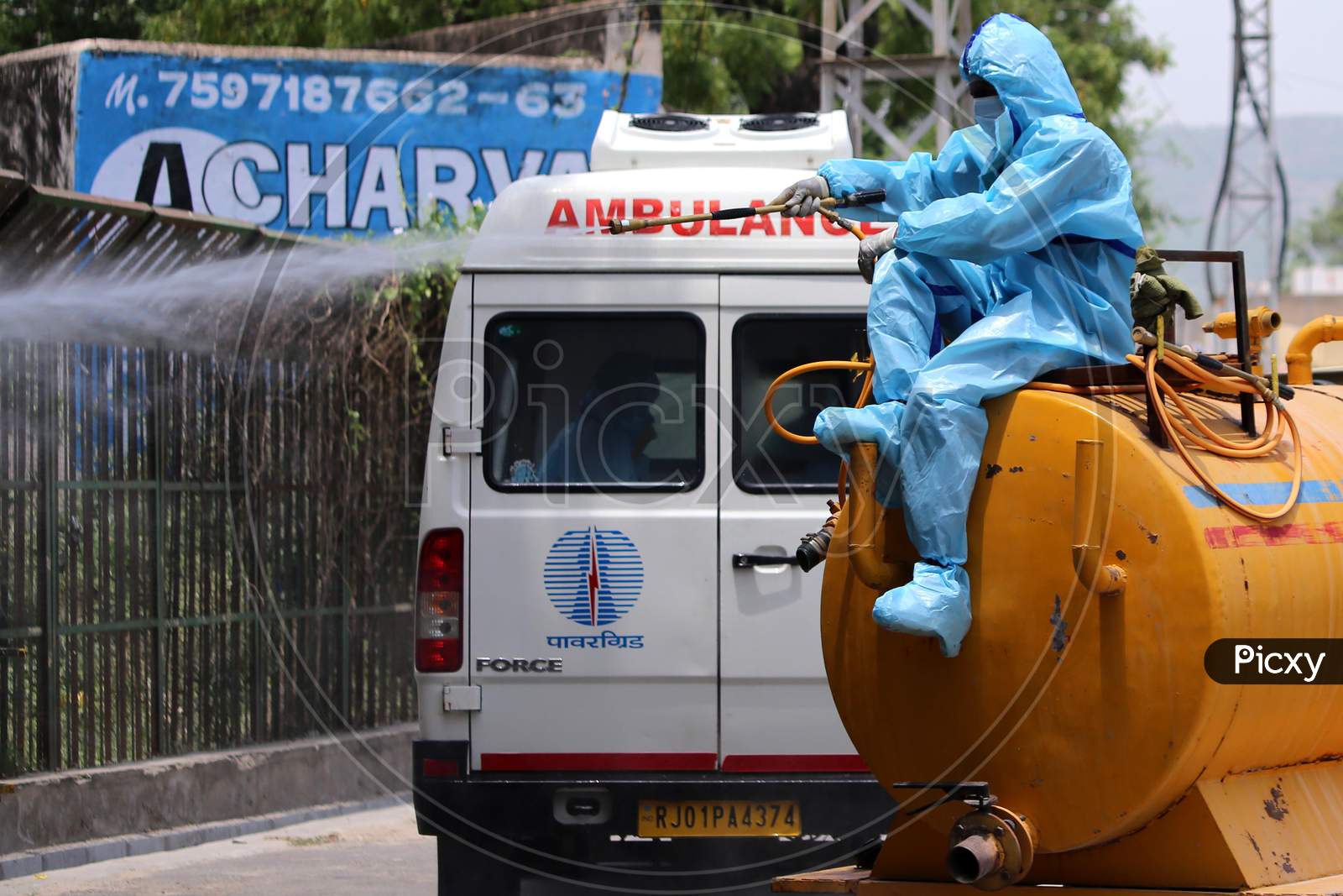 A municipal worker wearing a hazmat suit sprays disinfectant at a crematorium in Rajasthan on July 02, 2020.