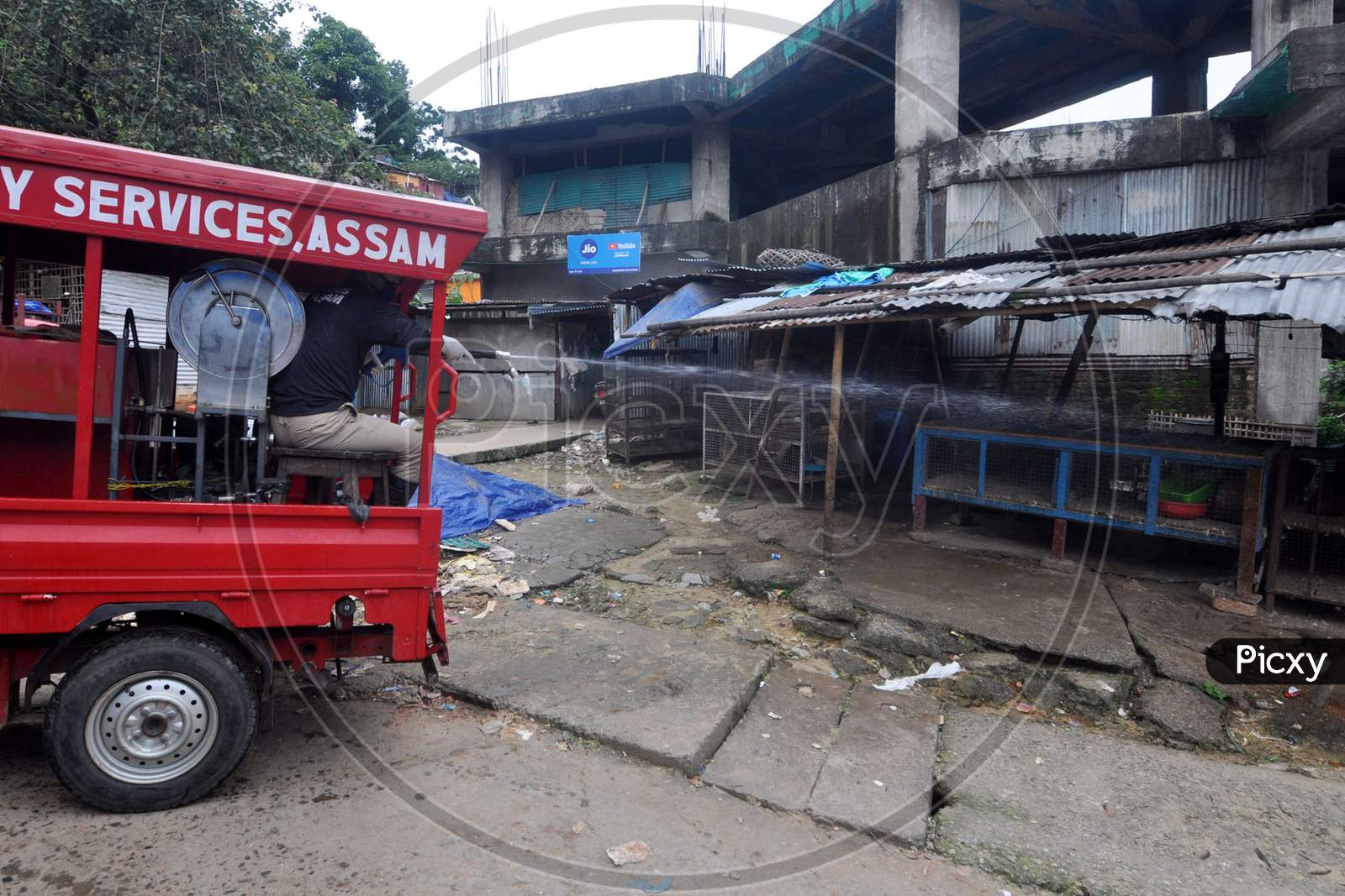 A firefighter sprays disinfectant in a local market area during lockdown in Guwahati, Assam on July 2, 2020