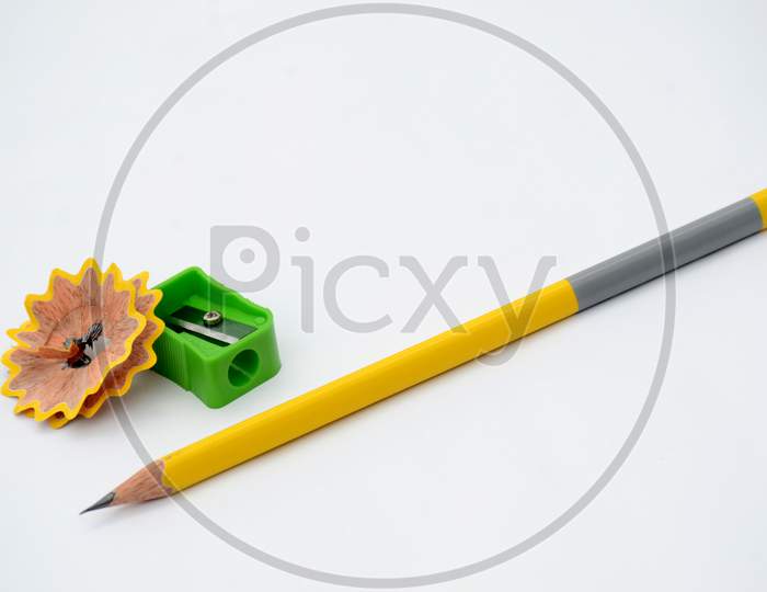 yellow wooden pencil with green sharpener isolated on white background.