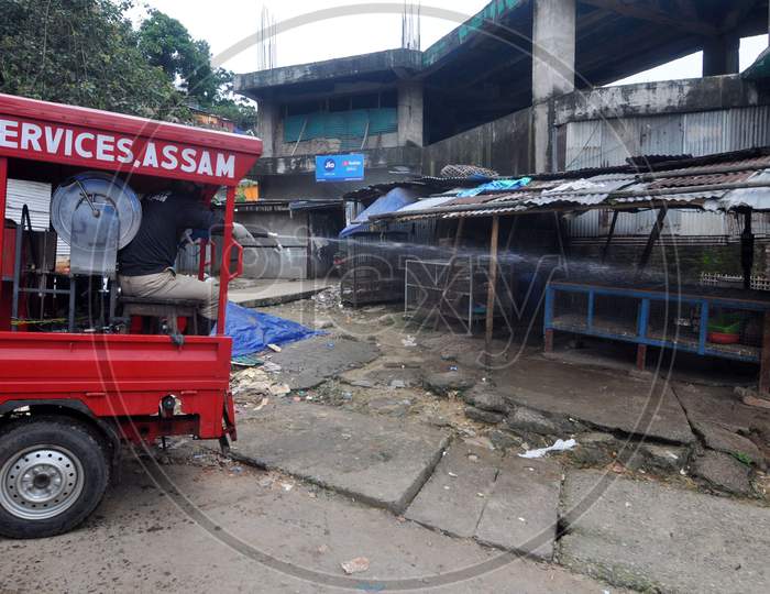 A firefighter sprays disinfectant in a local market area during lockdown in Guwahati, Assam on July 2, 2020