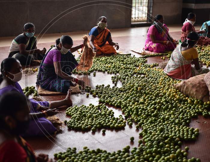 Workers prepare vegetable garlands ahead of the Shakhambari Devi festival at the Kanaka Durga temple in Vijayawada.