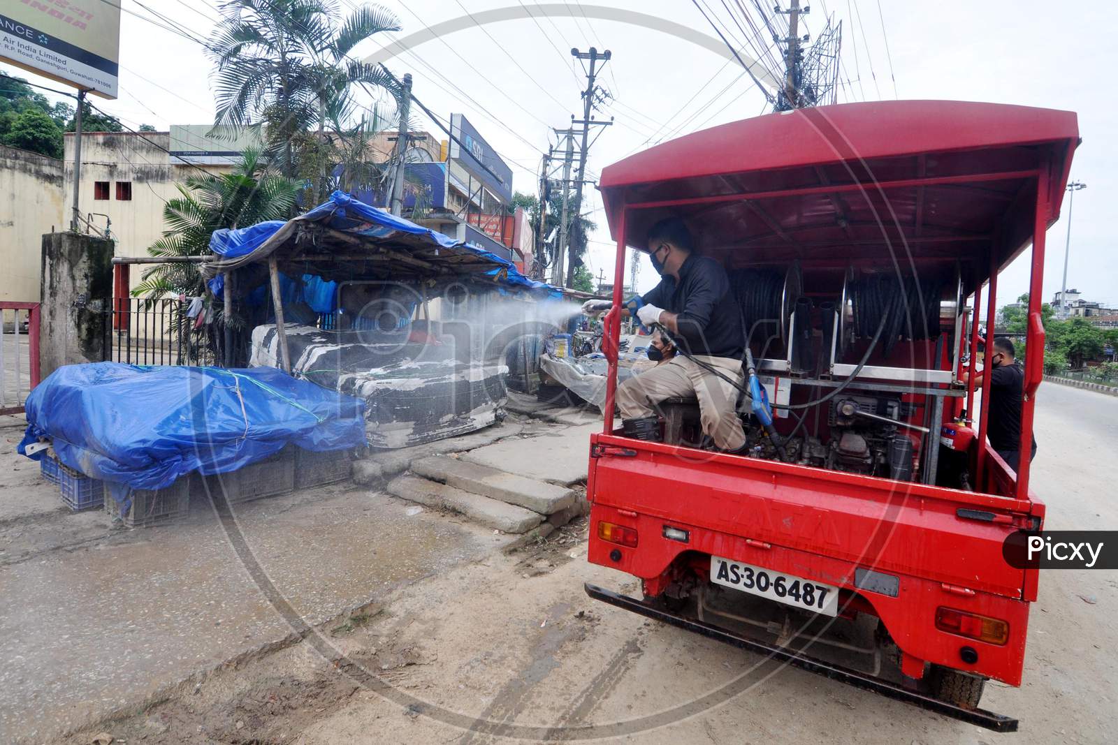 Firefighters spray disinfectant in a local market area during lockdown in Guwahati, Assam on July 2, 2020