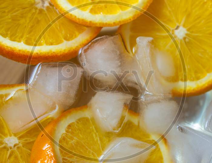 Top View Of Chill Water Infused With Sliced Oranges Which Is Good In Vitamin C. Immunity Boosting Drink.
