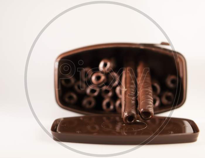 chocolate sticks in a box on a white background.