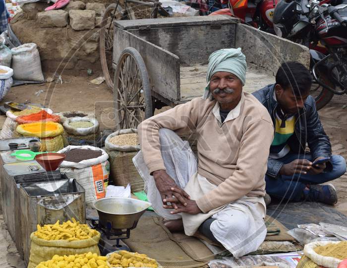 Man selling spices at market