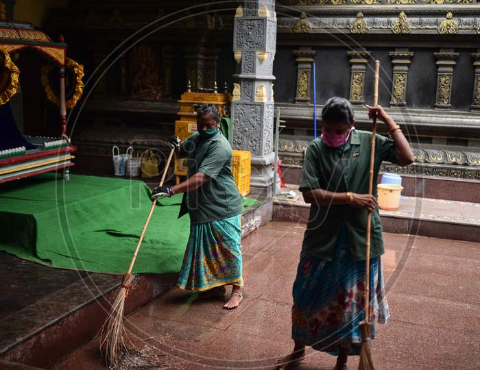 Sanitary workers clean the premises of the Kanaka Durga temple ahead of the Shakhambari Devi in Vijayawada.