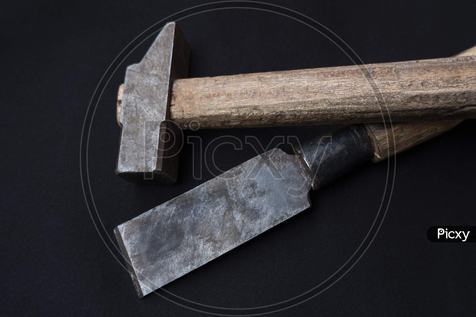 Closeup Shot Of A Hammer And Chisel With Wooden Handles Isolated On A Black Background