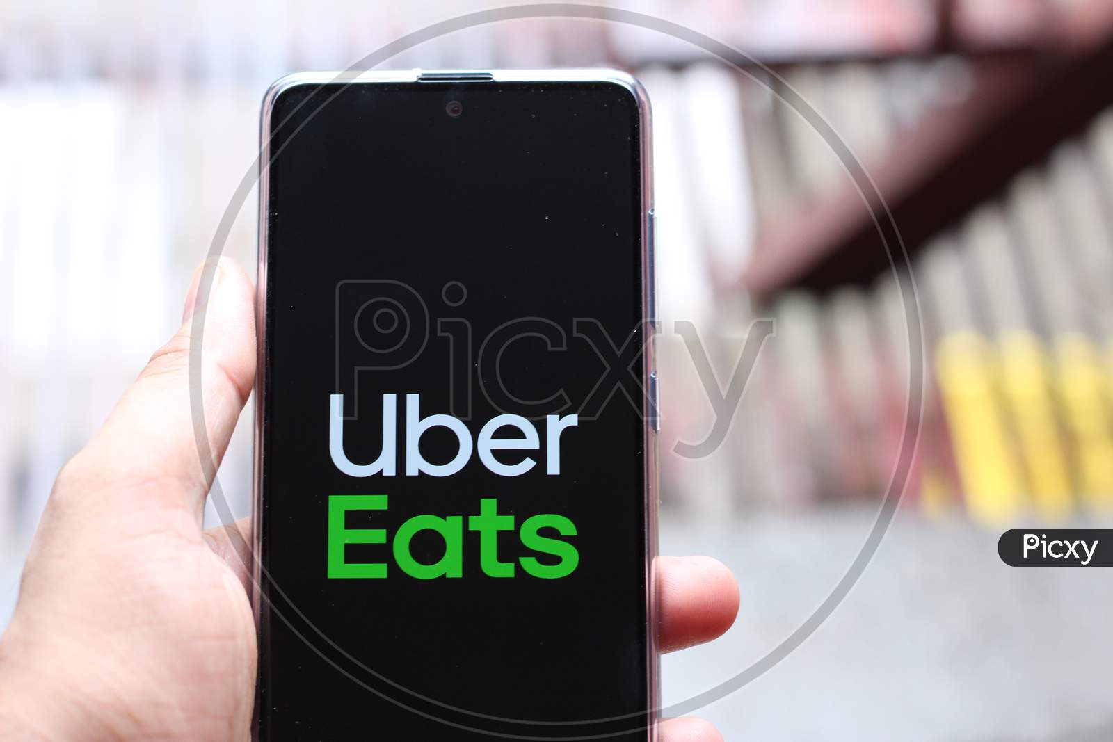 Uber eats application on smartphone with blurry background.