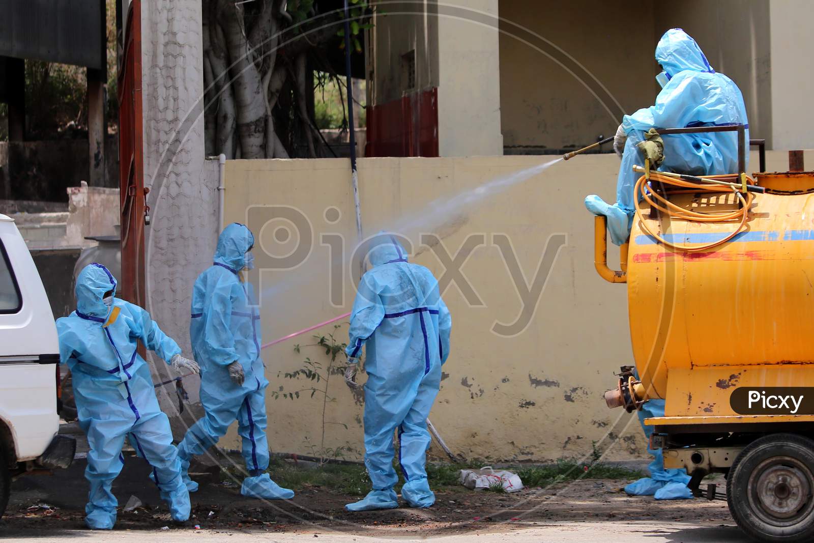 A municipal worker sprays disinfectant on his colleagues after they cremated a person who died of Covid-19 at a crematorium in Ajmer, Rajasthan on July 2, 2020.