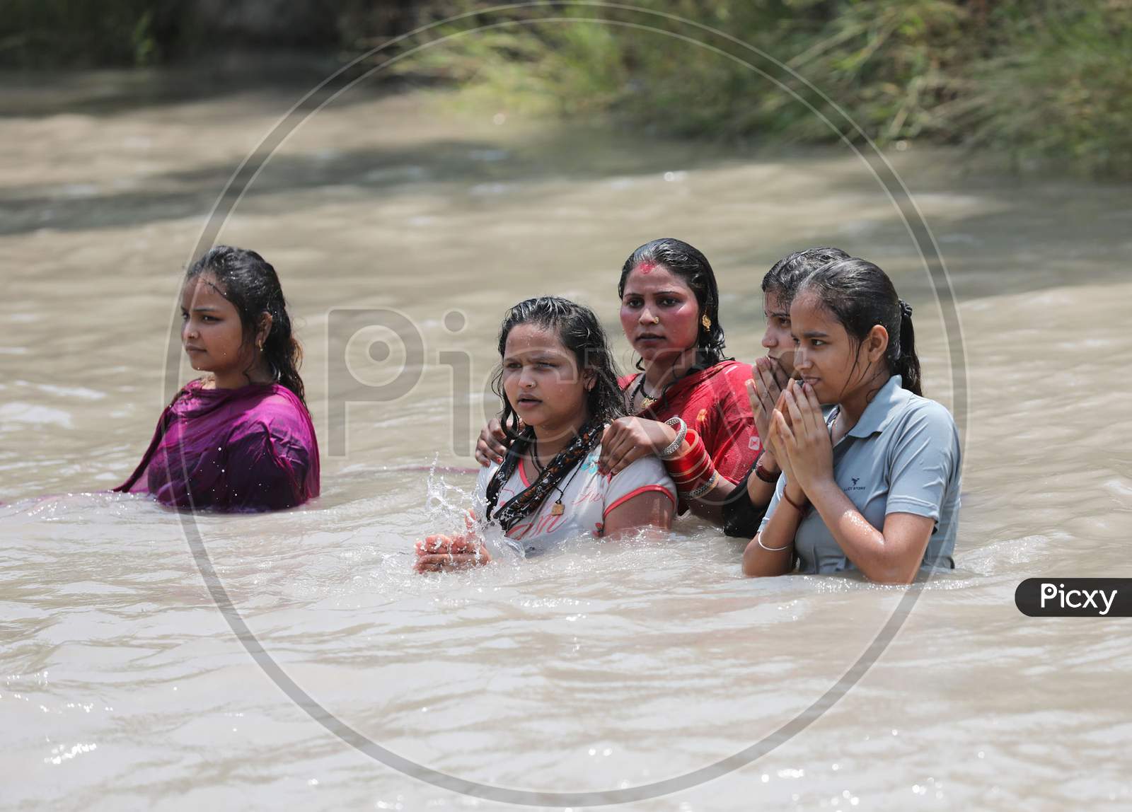 Women taking a dip in Ranbir Canal to beat the summer heat at Ranbir Canal in Jammu on July 2, 2020.