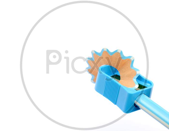 the blue wooden pencil with sharpner isolated on white background.