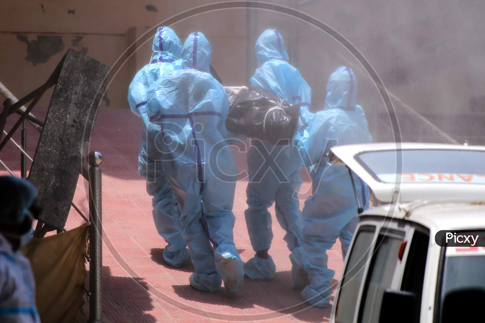 Health workers in hazmat suits carry the dead body of a person who died due to the coronavirus infection at a crematorium during the ongoing Covid-19 lockdown in Ajmer, Rajasthan on July 02, 2020.