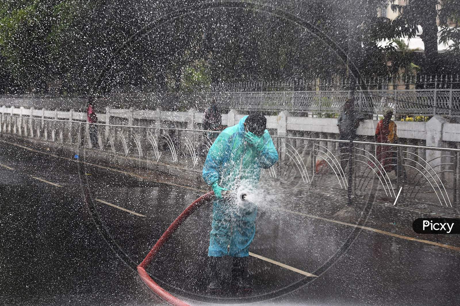 Firefighter spraying disinfectant on the roads to prevent the spread of Coronavirus in a containment zone in Chennai.