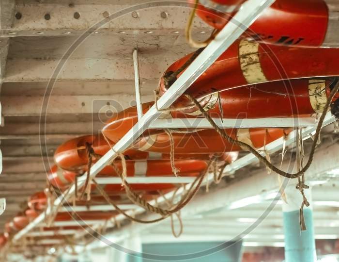 Line Of Lifebuoy Ring Floatation Inside A Traveler Ship . Blurry Background With Copy Space For Text .