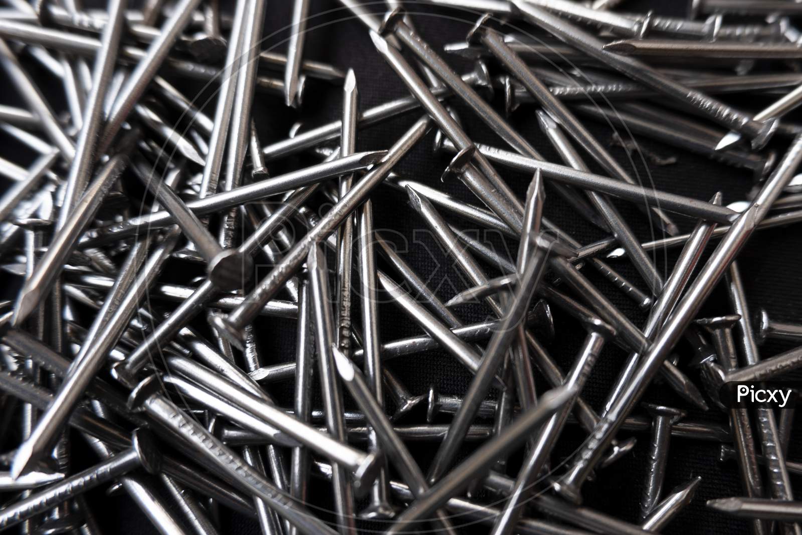 Closeup Shot Of A Pile Of Steel Nails On A Black Surface