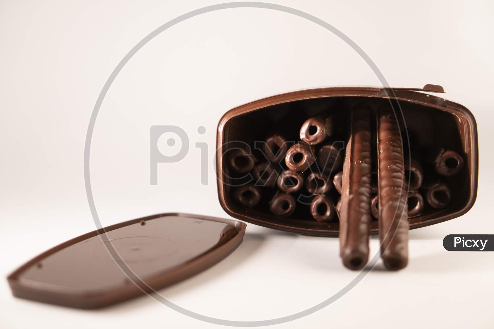 chocolate sticks in a box on a white background.