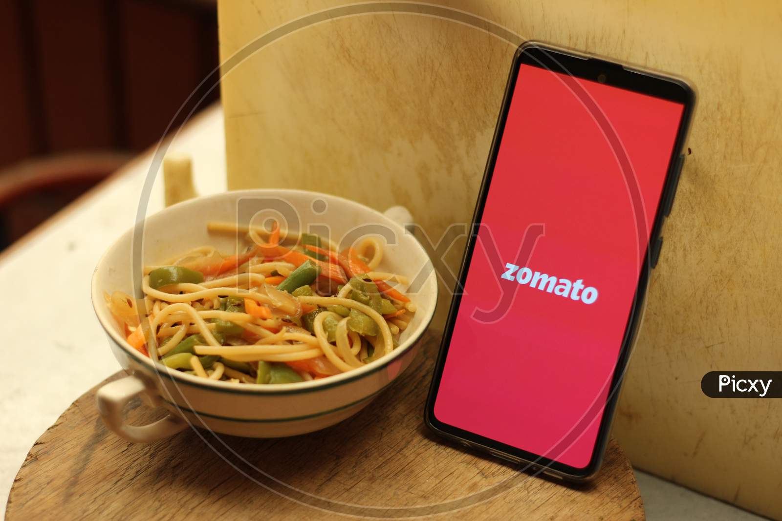 Zomato Food delivery application icon on smartphone.