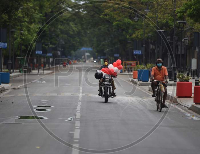 A motorist and a cyclist on a deserted road after the Government imposed a total lockdown in Chennai