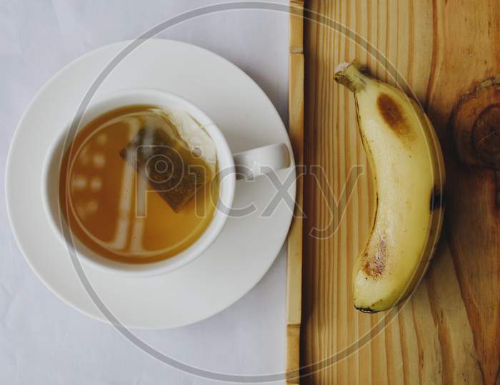 Green tea and one banana at morning breakfast