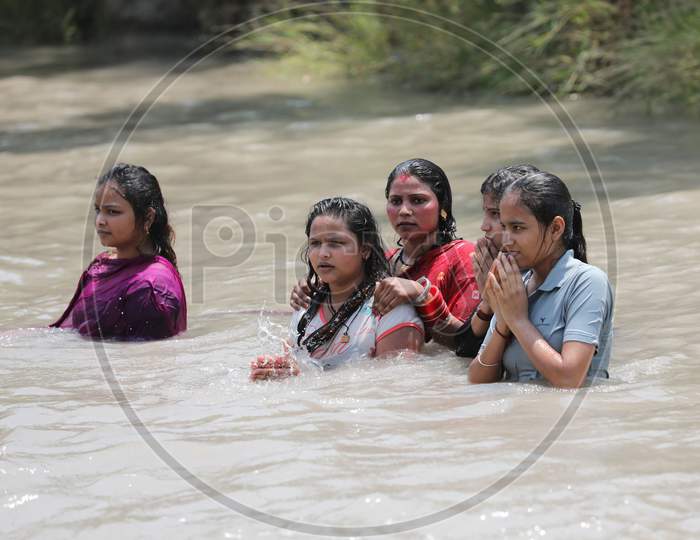 Women taking a dip in Ranbir Canal to beat the summer heat at Ranbir Canal in Jammu on July 2, 2020.