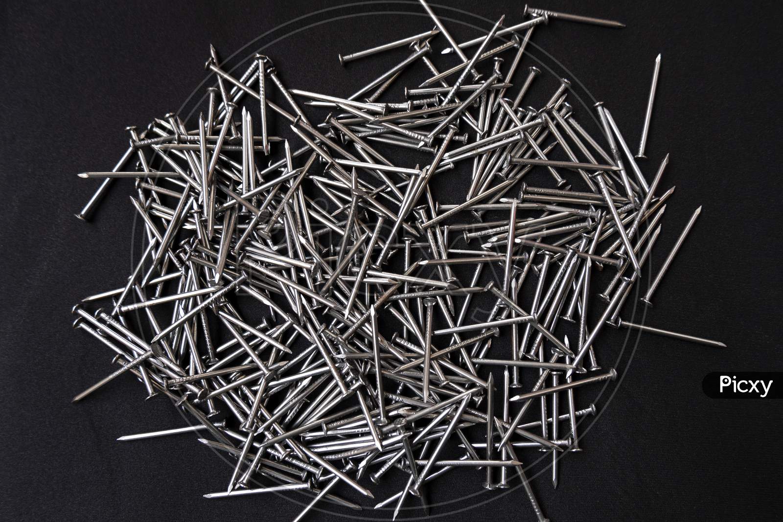 Closeup Shot Of A Pile Of Steel Nails On A Black Background