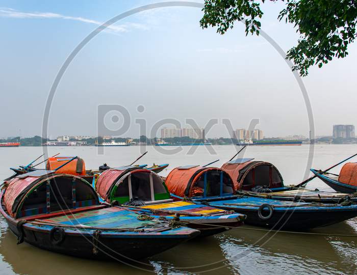 colourful photo of small boats in hooghly or Ganges river from princep ghat or Millennium Park kolkata west Bengal
