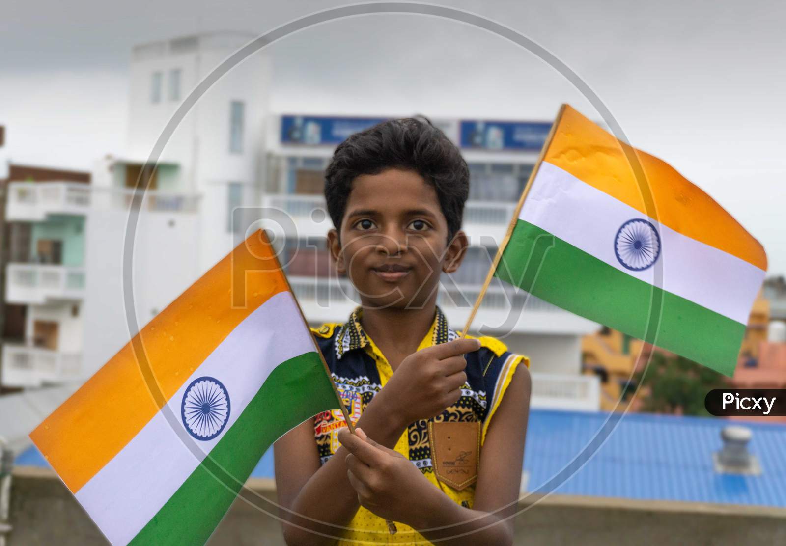 Patna, Bihar (India) July 19 2020   INDIAN BOY HOLDING WAVING INDIAN FLAG IN HIS HAND ON 15 AUGUST / 26 JANUARY REPUBLIC DAY