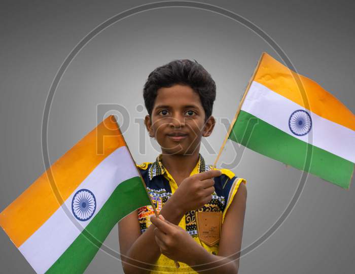 Patna, Bihar (India) July 19 2020   INDIAN BOY HOLDING WAVING INDIAN FLAG IN HIS HAND ON 15 AUGUST / 26 JANUARY REPUBLIC DAY