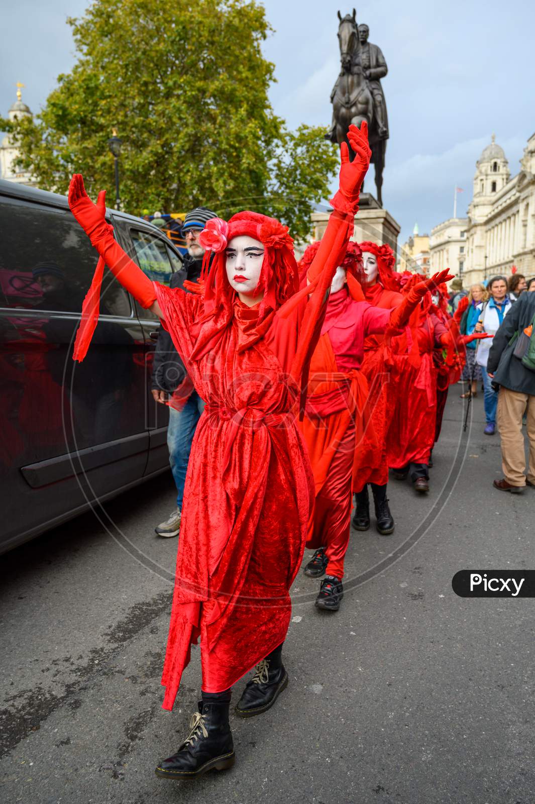 Full Length, Vertical Shot Of Red Brigade Protesters At An Extinction Rebellion Protest March Near Horse Guards Parade