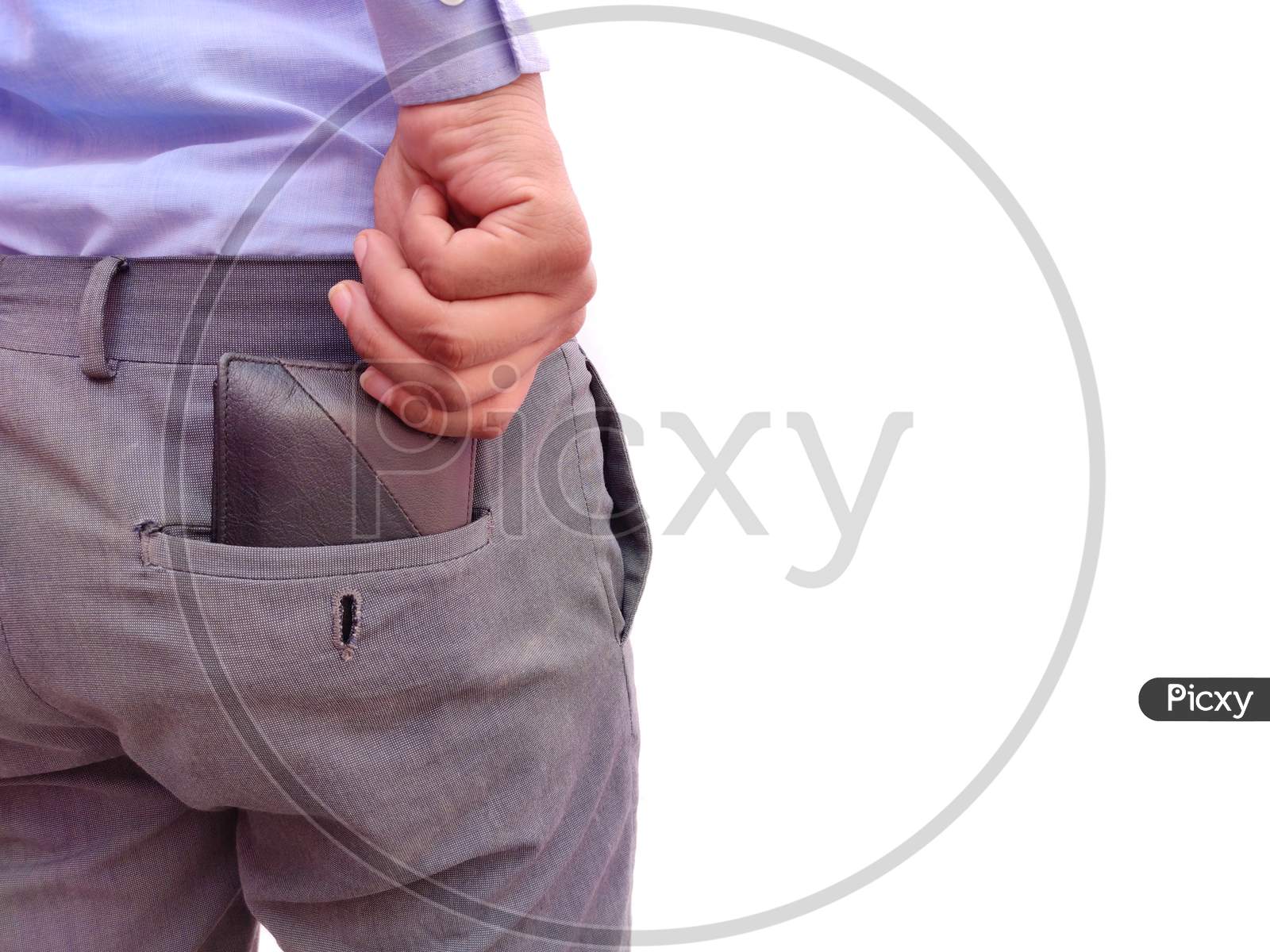 Rear View of man keeping money wallet in back pocket of formal pants on white background
