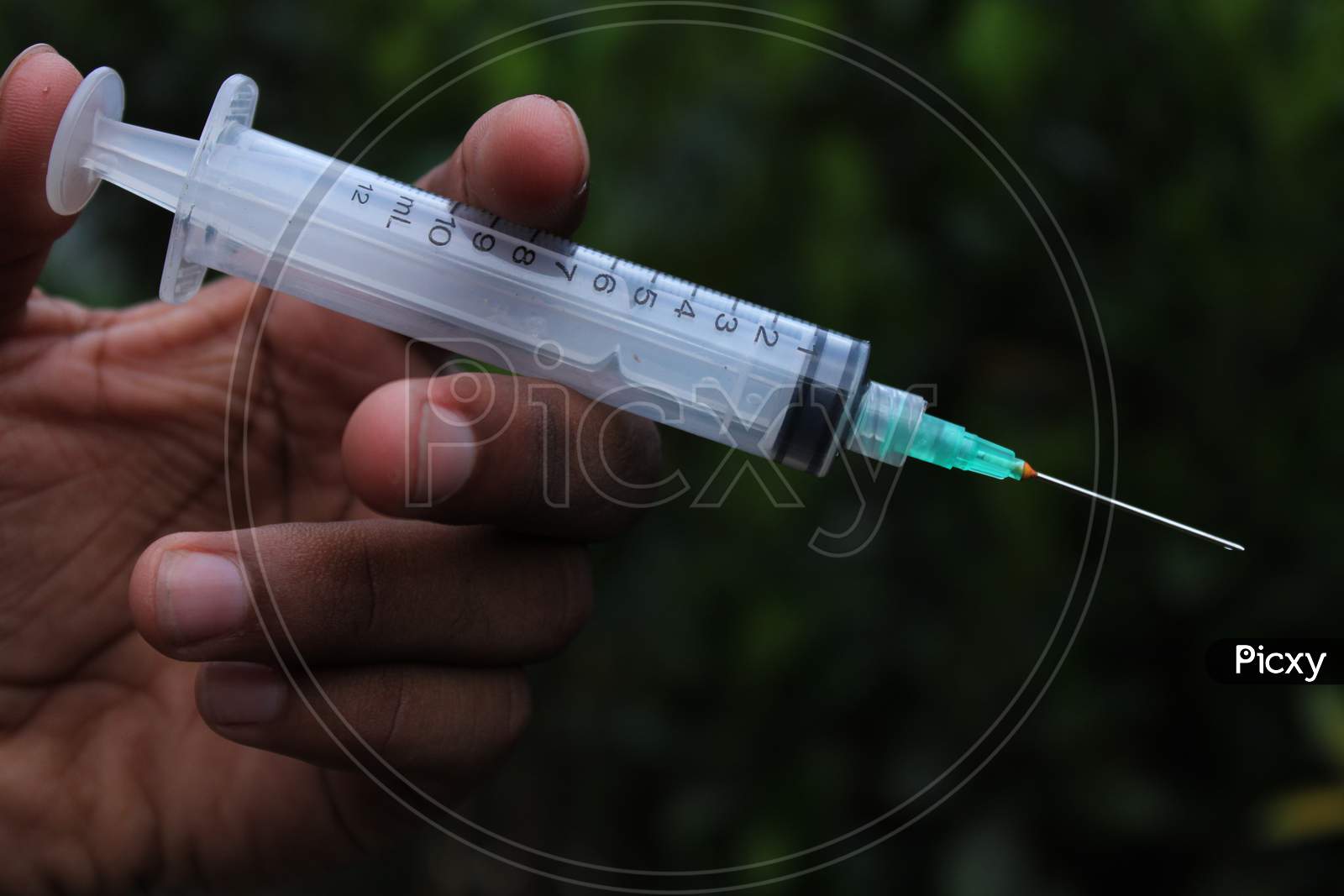 Disposable syringe in the hand