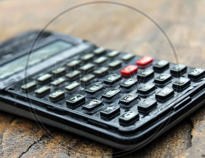 a wet scientific calculator  isolated on stone background