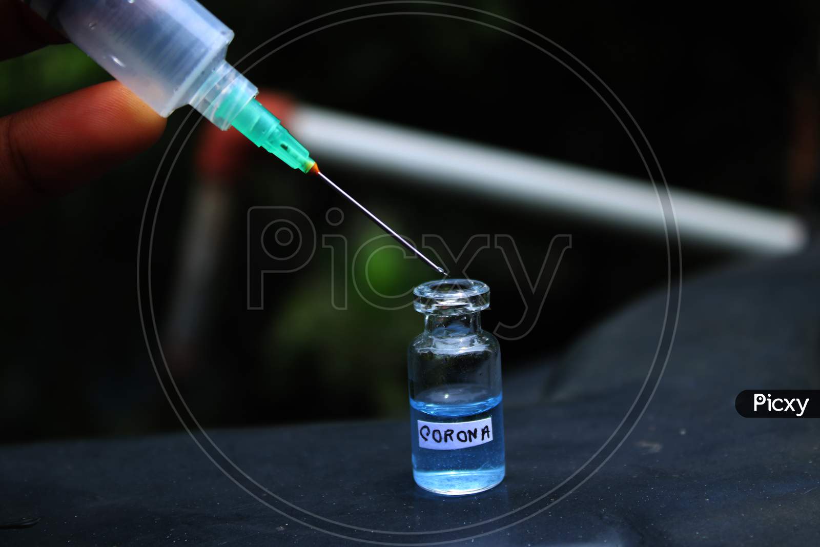Syringe with virus medicine bottle photo capture