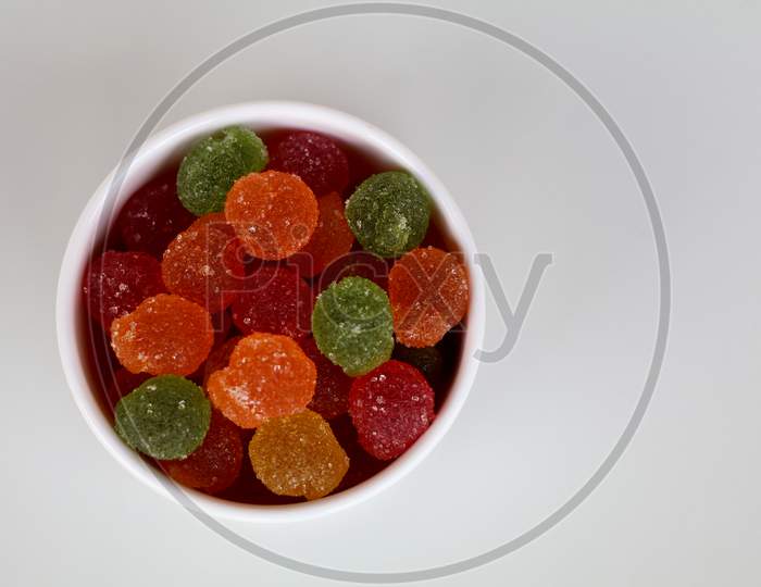 Sweet Mixed Color Jelly Candy In A White Bowl Against White Background With Copy Space