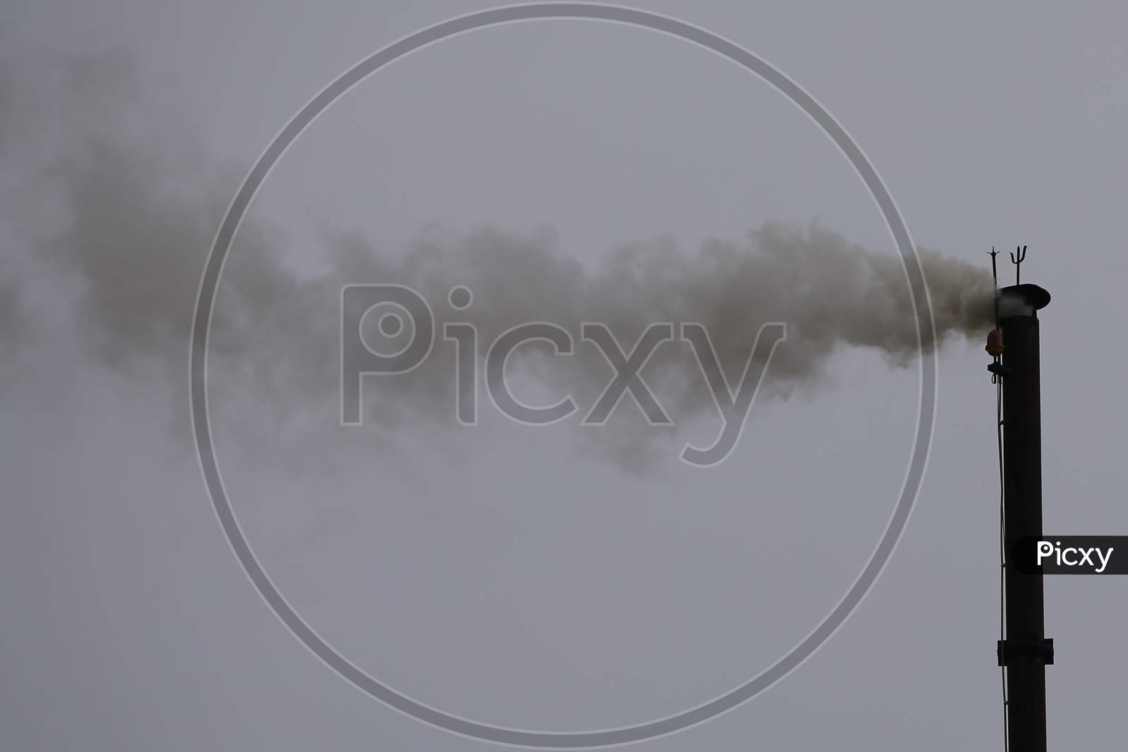 A chimney belonging to a crematorium emits smokes during the cremation of people who died due to coronavirus infection in Ajmer, Rajasthan on July 19, 2020