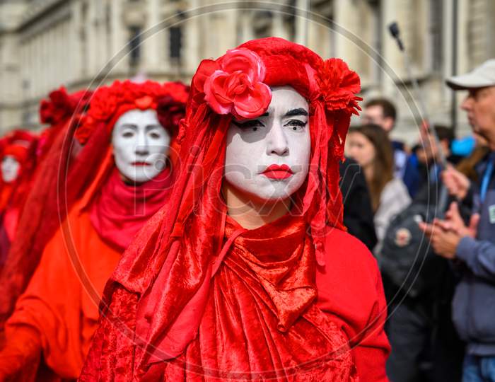 Close Up Of Red Brigade Protesters At An Extinction Rebellion Protest March