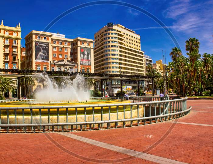 Malaga, Spain - September 03, 2015: Main City Center View Of Tourist Attraction Before Fountains Under Blue Sky