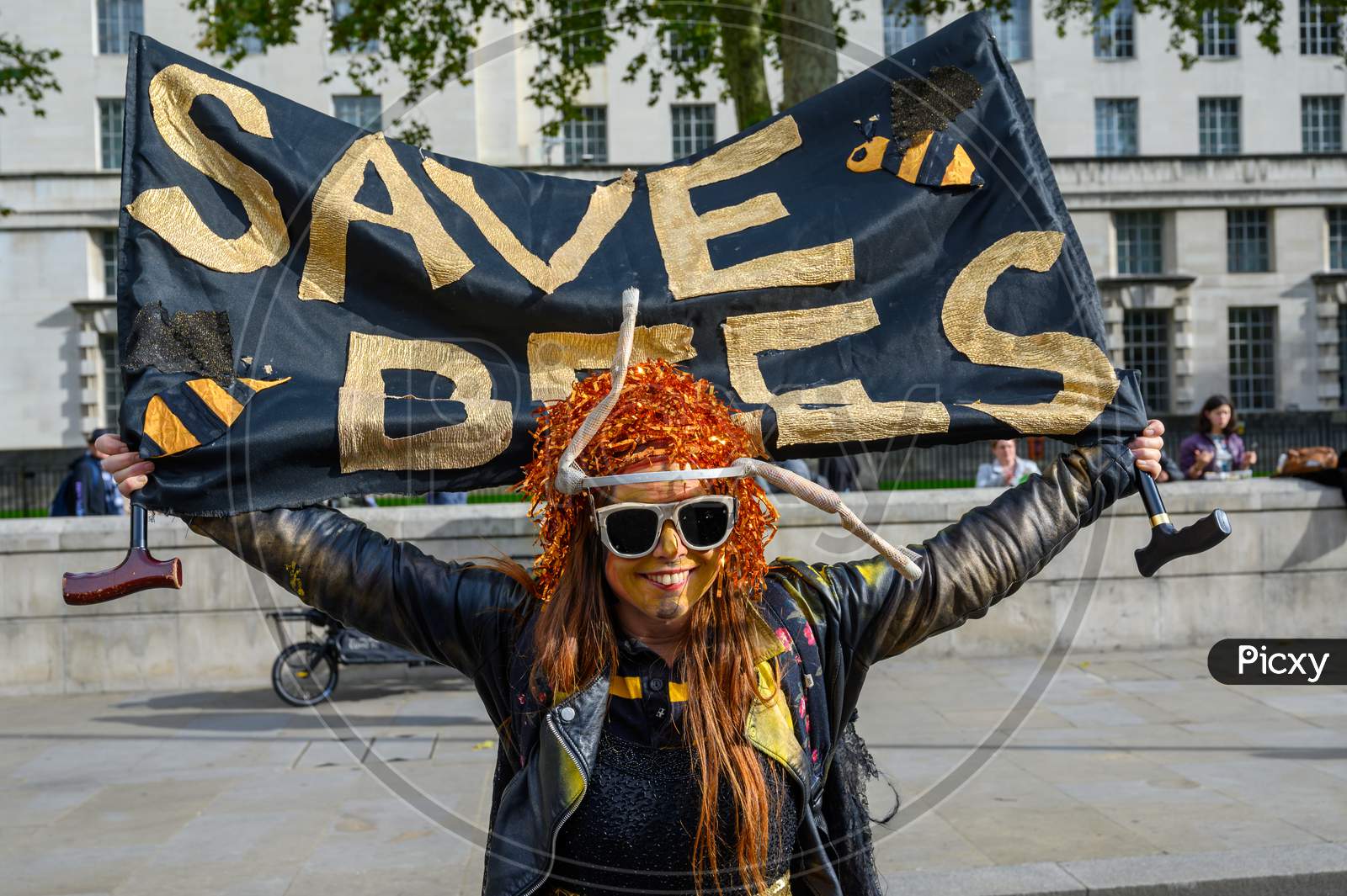 Extinction Rebellion Protester Holds A Save Bees Banner At An Extinction Rebellion Protest March
