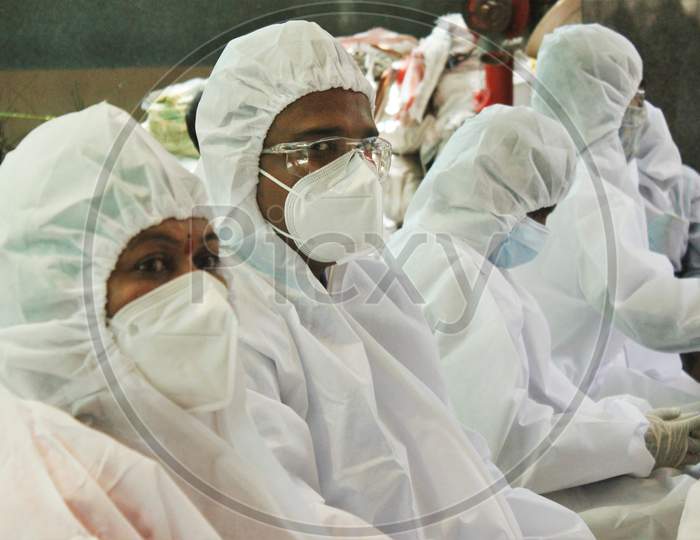 Healthcare workers wait for people during a check-up campaign for the coronavirus disease (COVID-19), in Mumbai, India on July 20, 2020.