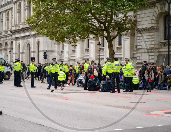 Metropolitan Police Officers Gather Ready To Move Extinction Rebellion Protesters From Sitting On The Road In Whitehall