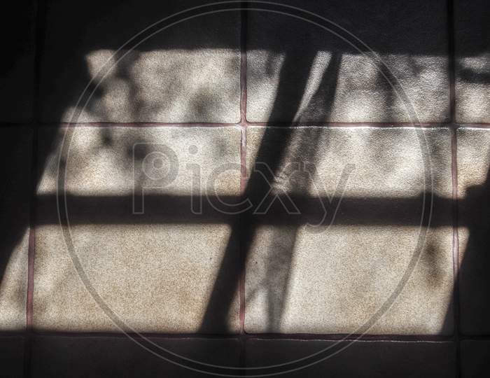 Abstract Concept Of Soft Shadows Of The Sunlight Through A Window On A Tile Background