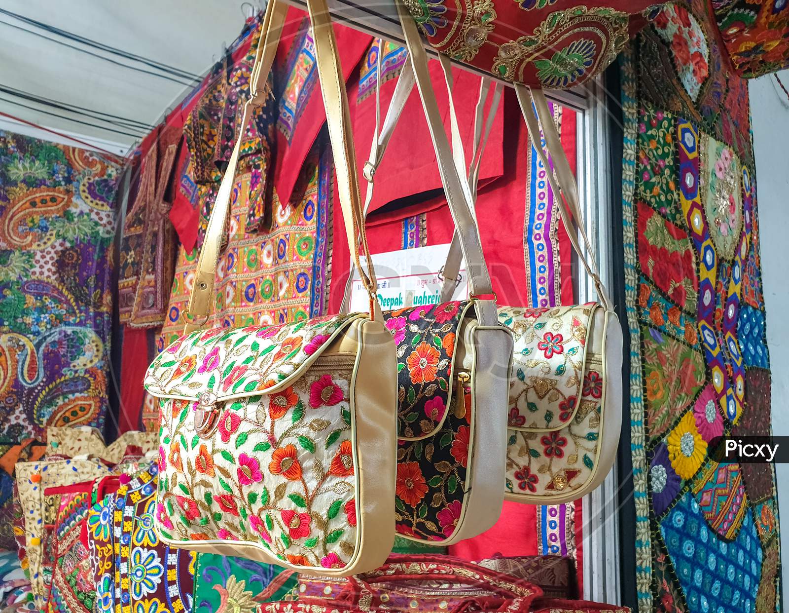 Mandi, Himachal Pradesh / India - 03 07 2020: Photo of beautiful Indian artwork shop: Unique Indian designed handbags hanging in the market for sale