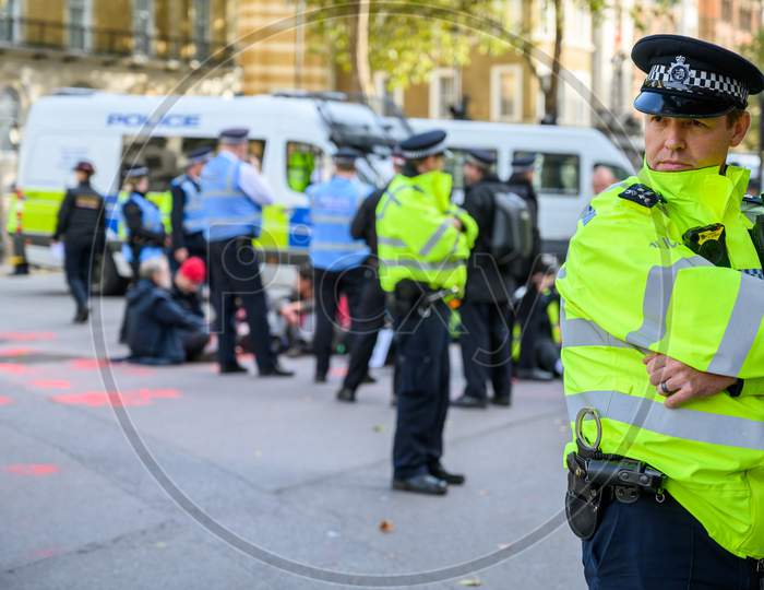 A Metropolitan Police Officer Stands Guard At An Extinction Rebellion Protest