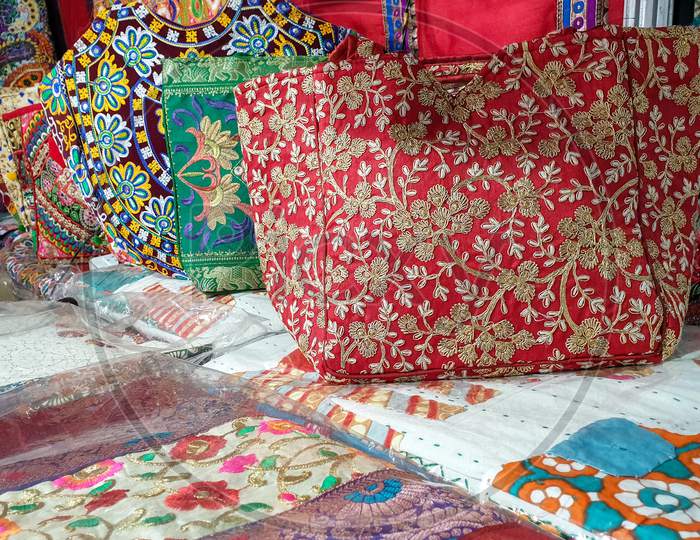 Mandi, Himachal Pradesh / India - 03 07 2020: Photo of colorful Indian artwork handbags kept in store for sale