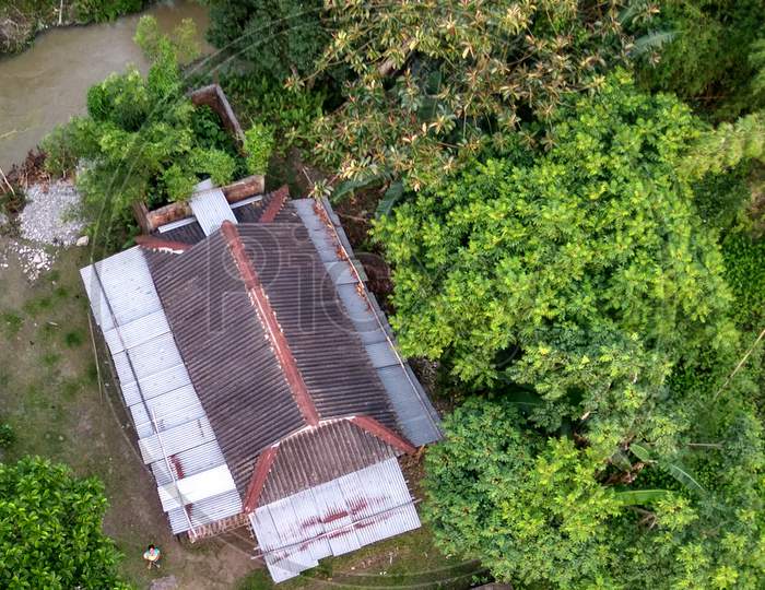 Aerial view of a house near a green tree